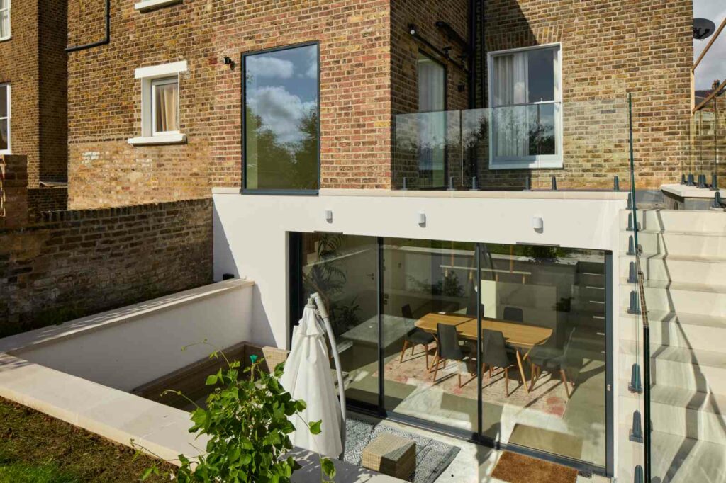 Basement conversion with glazed lightwell and sunken patio in London