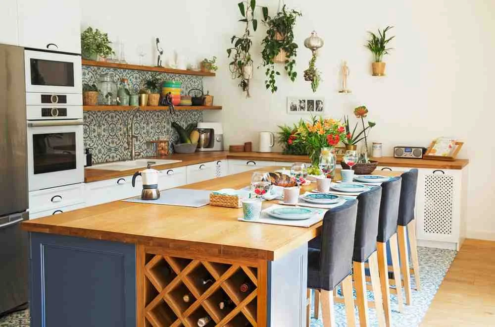 Kitchen Island Ideas featuring a modern wooden kitchen island with built-in wine storage, Kitchen Island Seating, bar stools, ample Kitchen Storage, and stylish Pendant Lighting inspiration for a functional Kitchen Layout.