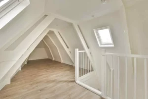 L Shaped Loft Conversion interior with exposed beams, roof windows, modern flooring, and additional living space in a Victorian terrace home