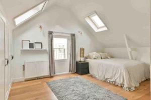 Types of Loft Conversion featuring a Velux Rooflight Loft Conversion bedroom with natural light, sloping roof design, and modern living space