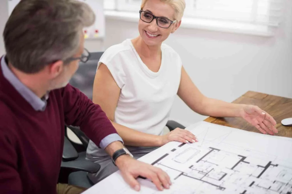 Homeowners meeting with a planning consultant to discuss How Long Does Planning Permission Last for a house extension planning application in the UK.