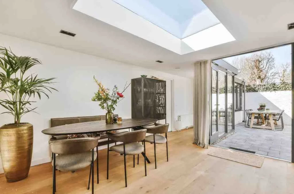 Modern Single Storey Rear Extension with a spacious dining area, large rooflight, bi-fold glass doors, Open-plan kitchen extension, elegant Rear extension design, functional Extension layout, and a contemporary Home extension project that maximises natural light and indoor-outdoor living.