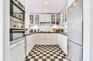 Modern U Shaped kitchen ideas featuring white shaker cabinets, black countertops, stainless steel appliances, checkerboard flooring, and smart storage for a small kitchen layout.
