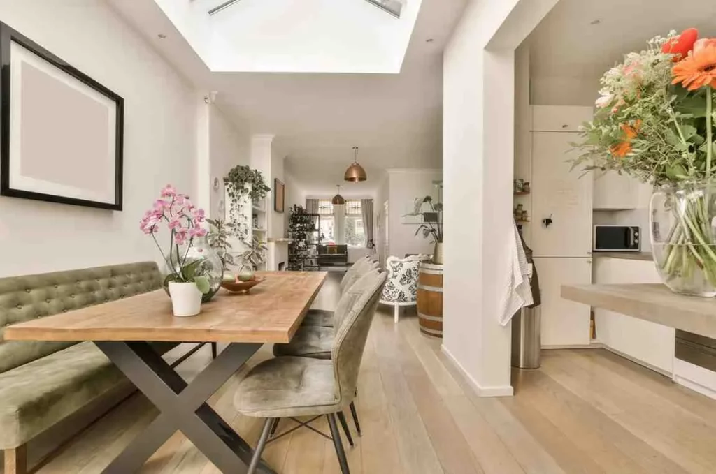 Modern open-plan kitchen and dining room showing a Side Return Extension Cost home improvement with rooflight, natural light, and contemporary interior design in a London terraced house.